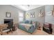 Cozy bedroom with modern decor featuring a daybed, desk, and unique wall art for a creative space at 13220 Swiftwater Way, Lakewood Ranch, FL 34211
