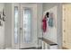 Inviting foyer with decorative glass door, bench, and coat rack at 13220 Swiftwater Way, Lakewood Ranch, FL 34211