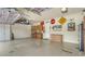 Spacious garage with storage cabinets, tool racks, and amusing road sign decor at 13220 Swiftwater Way, Lakewood Ranch, FL 34211