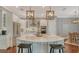 Spacious kitchen with large island, stainless steel appliances and modern lighting fixtures at 13220 Swiftwater Way, Lakewood Ranch, FL 34211
