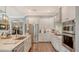 Bright kitchen features stainless steel appliances, white cabinets, and marble countertops at 13220 Swiftwater Way, Lakewood Ranch, FL 34211