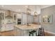Kitchen with large island, modern lighting, and stainless steel appliances at 13220 Swiftwater Way, Lakewood Ranch, FL 34211