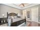 Spacious main bedroom includes a bed with two nightstands and lamps at 13220 Swiftwater Way, Lakewood Ranch, FL 34211