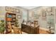 Home office with wooden desk, built-in bookcase, and baseball themed decor at 13220 Swiftwater Way, Lakewood Ranch, FL 34211