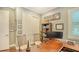 Home office with wooden desk, rolling chairs, and built-in bookcase at 13220 Swiftwater Way, Lakewood Ranch, FL 34211