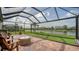 A covered patio featuring brick pavers, a fire pit, and lake views at 13220 Swiftwater Way, Lakewood Ranch, FL 34211