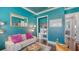 A stylish sitting room with textured blue walls, modern lighting, and eclectic furniture at 13220 Swiftwater Way, Lakewood Ranch, FL 34211