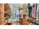 Spacious walk-in closet features custom wood shelving and ample storage for organizing clothes and accessories at 13220 Swiftwater Way, Lakewood Ranch, FL 34211