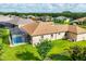 The aerial view shows a home with a screened pool, lush lawn, and a serene lakefront backdrop at 13503 22Nd E Ct, Parrish, FL 34219