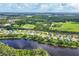 Wide aerial view of residential neighborhood with lush landscaping and lakes at 13503 22Nd E Ct, Parrish, FL 34219