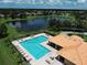 Aerial view of community pool, pond, and lush landscaping at 13503 22Nd E Ct, Parrish, FL 34219