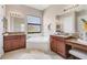 Bathroom features a soaking tub, double sinks, granite counters, and a large window for natural light at 13503 22Nd E Ct, Parrish, FL 34219