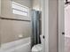 Bathroom featuring tile walls, a shower curtain, and a toilet at 13503 22Nd E Ct, Parrish, FL 34219