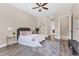 Cozy bedroom featuring neutral paint, a decorative headboard, and a plush rug on laminate flooring at 13503 22Nd E Ct, Parrish, FL 34219