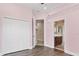 Pink bedroom featuring wood flooring and a view into the bathroom at 13503 22Nd E Ct, Parrish, FL 34219