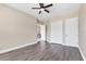 Bedroom with wood flooring, a ceiling fan, and access to other rooms at 13503 22Nd E Ct, Parrish, FL 34219