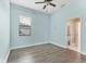 A bedroom features laminate flooring, one window for natural light, and access to an attached bathroom at 13503 22Nd E Ct, Parrish, FL 34219