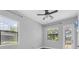 Bedroom with hardwood floors, ceiling fan, and views of lake and pool at 13503 22Nd E Ct, Parrish, FL 34219