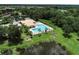 Aerial view of the community pool area, complete with a bathhouse and landscaped grounds at 13503 22Nd E Ct, Parrish, FL 34219