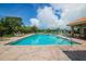 Inviting community pool with brick pavers and ample seating, perfect for relaxation and recreation at 13503 22Nd E Ct, Parrish, FL 34219