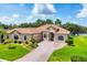 Stunning single-story home with well-manicured lawn and elegant brick-paved driveway leading to a two-car garage at 13503 22Nd E Ct, Parrish, FL 34219