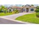 Attractive single-Gathering home with a brick driveway, attached two-car garage, and manicured front lawn at 13503 22Nd E Ct, Parrish, FL 34219