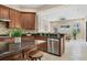 Well-appointed kitchen with granite counters, stainless steel appliances, mosaic backsplash, and an open layout at 13503 22Nd E Ct, Parrish, FL 34219