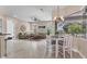 Open living area featuring tile floors, comfortable seating, and natural light from large windows at 13503 22Nd E Ct, Parrish, FL 34219