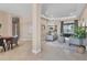 Open concept living space featuring tiled floors, tray ceilings, and views of the backyard at 13503 22Nd E Ct, Parrish, FL 34219