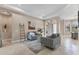 Open-concept living room with neutral tones, tile flooring, and tray ceiling at 13503 22Nd E Ct, Parrish, FL 34219