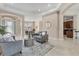 Elegant living room with neutral decor, tile floors, and arched doorways at 13503 22Nd E Ct, Parrish, FL 34219