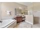 Elegant bathroom features a soaking tub, vanity area, and a glass-enclosed shower at 13503 22Nd E Ct, Parrish, FL 34219