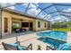 The covered patio and screened pool offer a seamless blend of indoor and outdoor living spaces for relaxing and entertaining at 13503 22Nd E Ct, Parrish, FL 34219