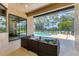 Inviting covered patio with comfortable seating overlooking the pool and picturesque water view at 13503 22Nd E Ct, Parrish, FL 34219