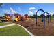 Colorful community playground with multiple slides, climbing areas, swings, and a cushioned surface at 13503 22Nd E Ct, Parrish, FL 34219