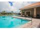 A beautiful community pool featuring a covered seating area and clear blue water at 13503 22Nd E Ct, Parrish, FL 34219