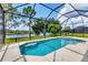 Enjoy a stunning screened-in pool and spa area with serene lake views, perfect for entertaining at 13503 22Nd E Ct, Parrish, FL 34219
