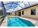 View of the screened pool with a spa and ample space on the pool deck at 13503 22Nd E Ct, Parrish, FL 34219