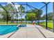 Stunning screened-in pool and spa with serene lake views, ideal for outdoor relaxation and entertainment at 13503 22Nd E Ct, Parrish, FL 34219