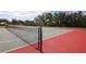 Well-maintained community tennis court featuring a red and green surface ready for play at 13503 22Nd E Ct, Parrish, FL 34219