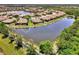 A lovely house with a tile roof backs to a lake at 1375 Backspin Dr, Englewood, FL 34223