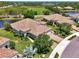 Elevated view of a community home with a water view and a red tile roof at 1375 Backspin Dr, Englewood, FL 34223
