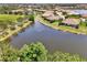 Beautiful aerial view of a landscaped community with pond at 1375 Backspin Dr, Englewood, FL 34223
