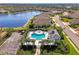 Beautiful aerial view of a lakefront community with a large pool at 1375 Backspin Dr, Englewood, FL 34223