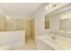 Well-lit bathroom featuring a double vanity, toilet, and frameless glass shower with beige tile surround at 1375 Backspin Dr, Englewood, FL 34223