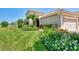 Beautifully landscaped front yard with vibrant flowers and manicured hedges at 1375 Backspin Dr, Englewood, FL 34223