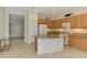 Well-lit kitchen boasts an island with granite countertops, ample cabinetry, and modern appliances at 1375 Backspin Dr, Englewood, FL 34223