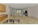Kitchen with granite island opens into the living area, offering modern stainless steel sink and cabinets at 1375 Backspin Dr, Englewood, FL 34223