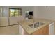Bright living room with stylish furniture, including large glass sliding doors, and views of the outdoor scenery at 1375 Backspin Dr, Englewood, FL 34223