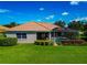 Well-manicured backyard with lush greenery, a screened pool, and an inviting outdoor space at 14714 5Th Ne Ter, Bradenton, FL 34212